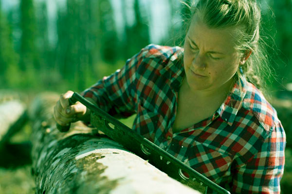 Image of Ashley Shelden as a log peelers