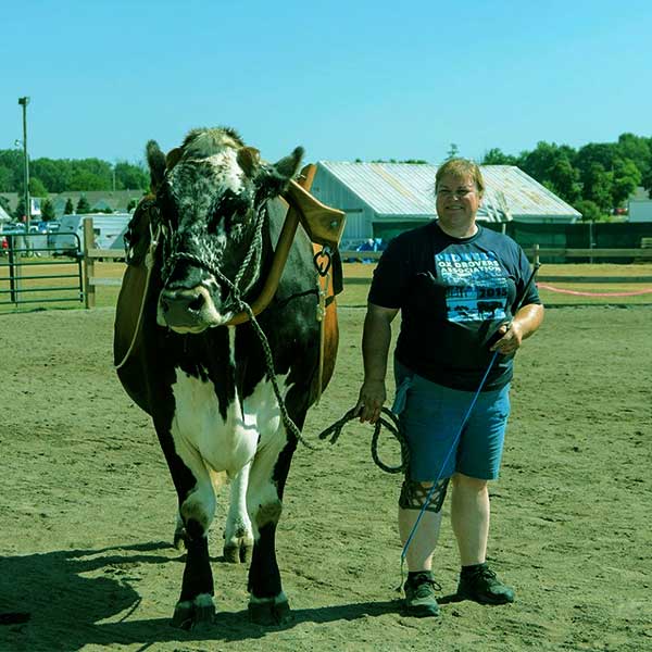 Image of Dr.Brenda spending time with her pet Oxen